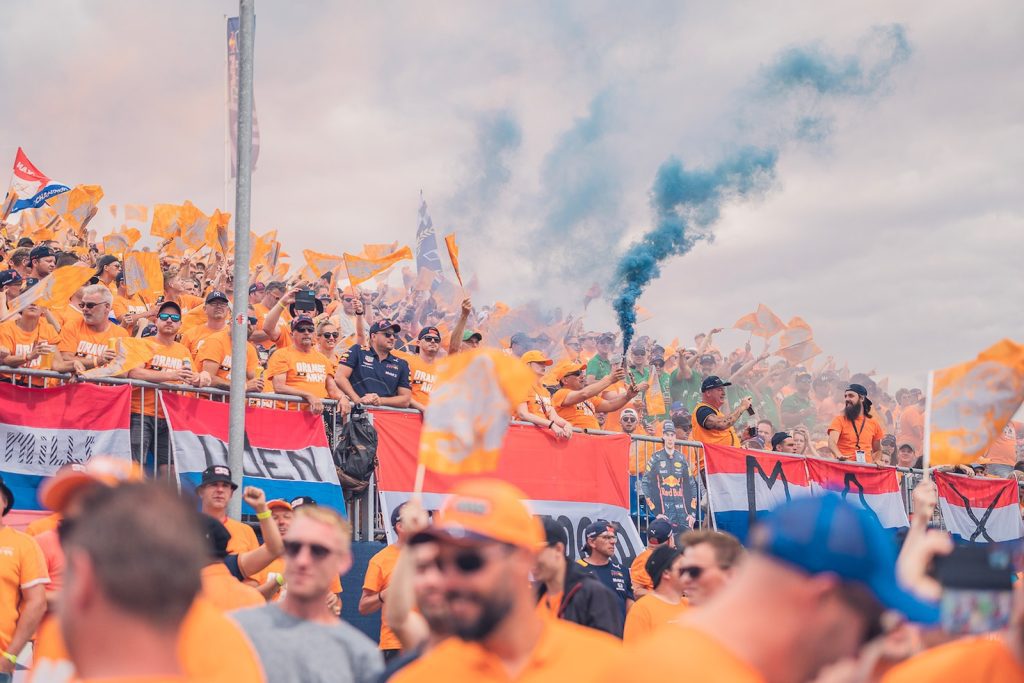 a crowd of people holding flags